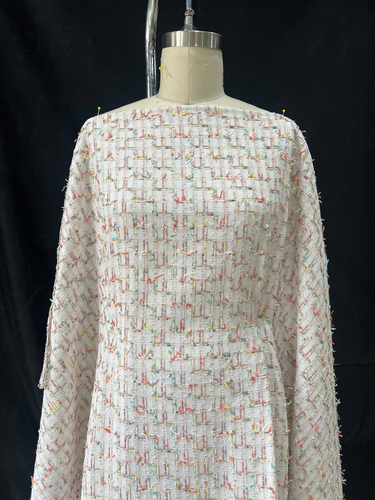 Linton Tweeds fabric featuring white cream base with metallic pink, gold, and multicolored couture boucle textures.